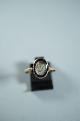 une image représentant une bague en or dans laquelle est incrustée une pièce romaine
