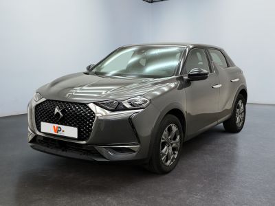 the front view of a grey car in a showroom