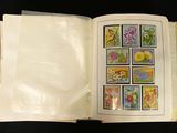 an open book with stamps on it on a black surface
