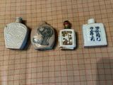 trois petites bouteilles portant des inscriptions en caractères asiatiques, posées sur une table