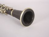 a clarinet that is sitting on a white surface