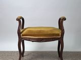 a small bench with a yellow cushion on top of it