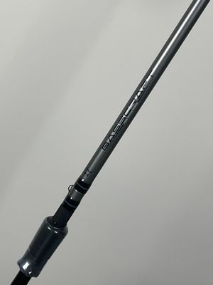 a close up of a fishing rod on a white surface
