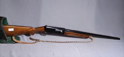 the rifle is laying on the table with a chain around it