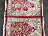 deux tapis rouges et blancs posés sur un sol en béton