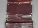 a close up of a brown leather wallet on a table