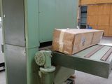 a machine that is moving boxes on a pallet