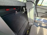 a seat in the back of a car with the back seats folded down