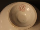 a white bowl sitting on top of a black table