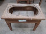 a wooden table with a hole in the middle of it