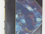 an image of a blue and black book with a gold trim