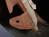 a close up of a wooden shoe with a bow on it