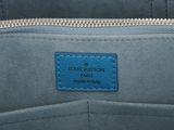 the inside of a blue purse with a blue tag on it