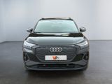 the front view of a grey audi suv parked in a white room