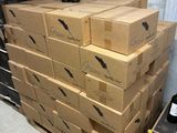 boxes of wine are stacked on top of each other in a room