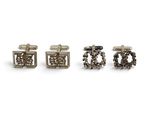three pairs of silver cufflinks on a white background
