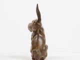 bronze sculpture of a dog on a white background
