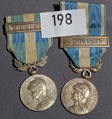 two medals that have been placed on a table