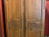 an image of a wooden armoire in a room with a red wall