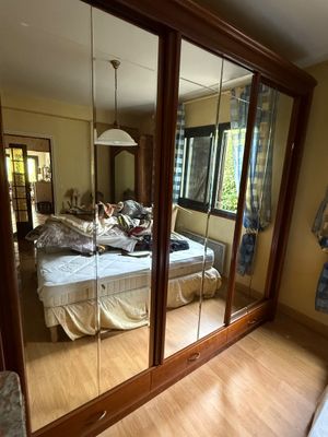 a bedroom with a bed and a mirror on the wall