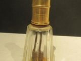 a small glass bottle with a gold top on a table