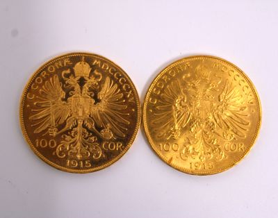 two pieces of gold coins, one of which is a double headed eagle and the other of which is a double headed eagle