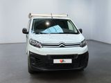 the white van is parked in a white room with a black floor