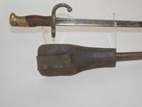 an old sword with a wooden handle on a white surface