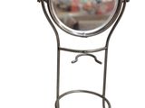 mirror on a stand on a white background with a reflection of a building in the background