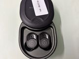 a pair of ear buds in a case on a table