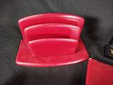a red chair that is sitting next to a red chair