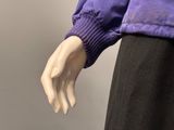 a mannequin wearing a purple jacket and black pants