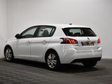the rear end of a white car parked in a garage
