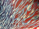 a close up of a skateboard with a red and blue design on it