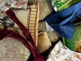 a pile of different colored pillows on the floor