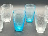 six glasses that are sitting on a table