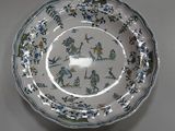 a white plate with blue flowers and birds on it