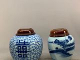 two blue and white vases with asian writing on them