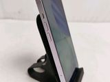 a cell phone that is on a stand on a table