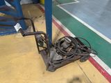 an image of a hand truck with a hose attached to it