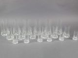 a lot of glasses that are lined up on the table
