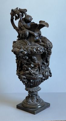 a statue of a man riding a horse on top of a vase