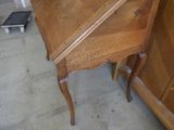 a small wooden desk with a drawer underneath it