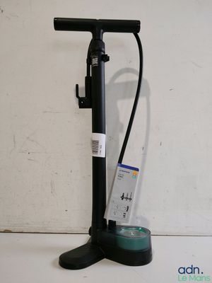 a close up of a pump on a counter with a bottle of water
