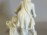 a figurine of a man riding on a horse