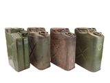 three old metal cans are lined up on a white surface