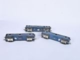 three toy trains sitting on a white surface