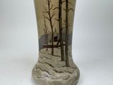 a vase that has a picture of trees on it