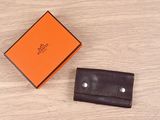 an orange box and a brown wallet on a wooden table