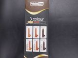 a box with three different colors of hair products in it